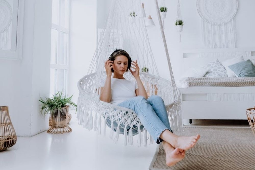 woman with headphones on chair