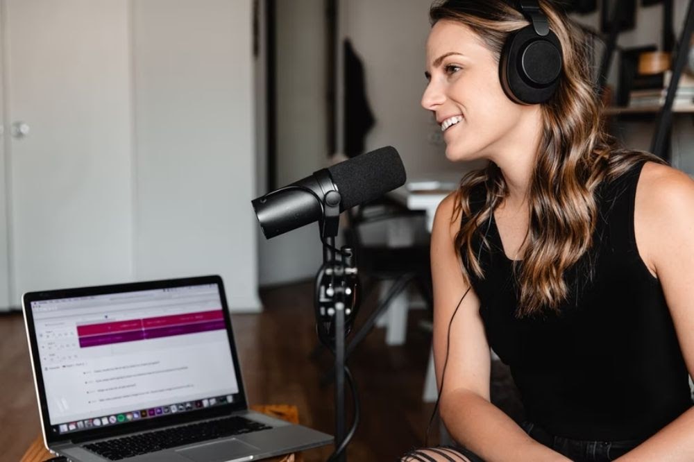 girl smiling using podcast technology