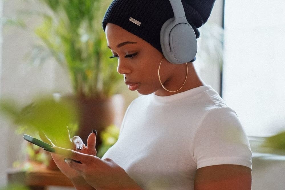 woman with headphones on phone