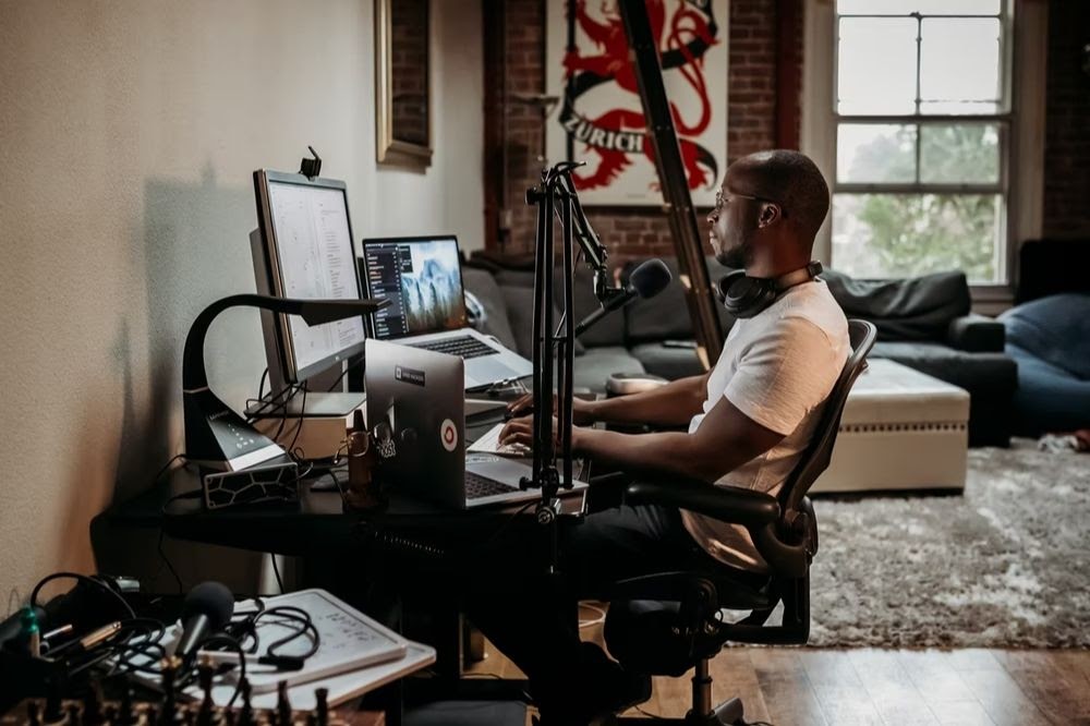 man at podcasting desk