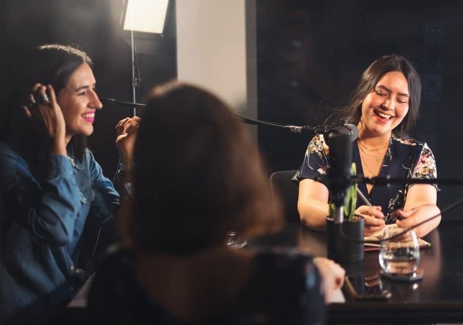 A group of podcasters using the  equipment while on air