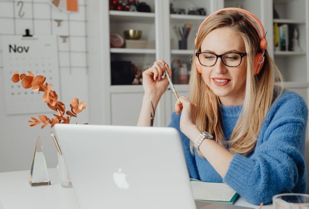 a woman running paid ads on Pinterest using her laptop