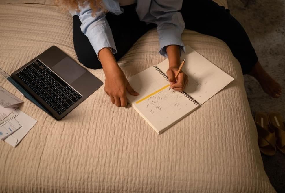 a woman writing down her plans for selling on Pinterest