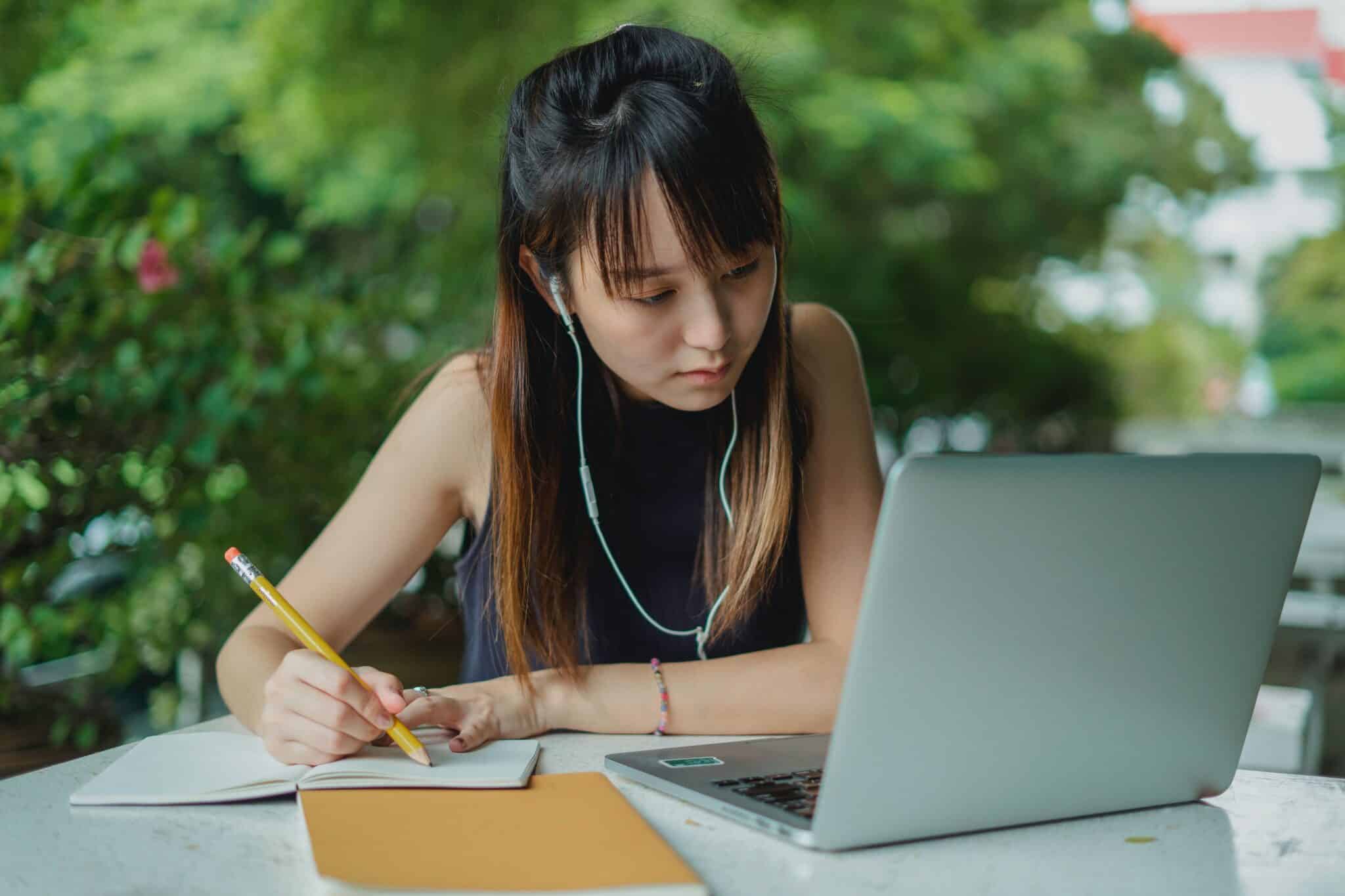 A student listening to an available podcast online to get more insight about a specific topic