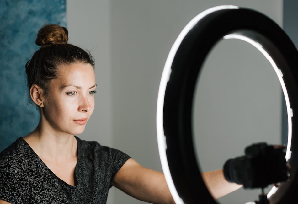 a woman setting up her equipment to market the video teaser of her podcast