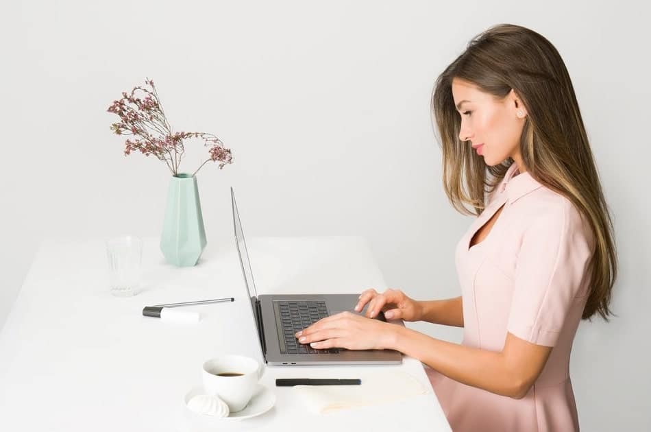 a woman looking for some audio files to repurpose on her laptop