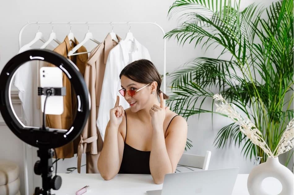 female podcaster shooting her video with sound effects coming from the video editing platform to be added during post-production