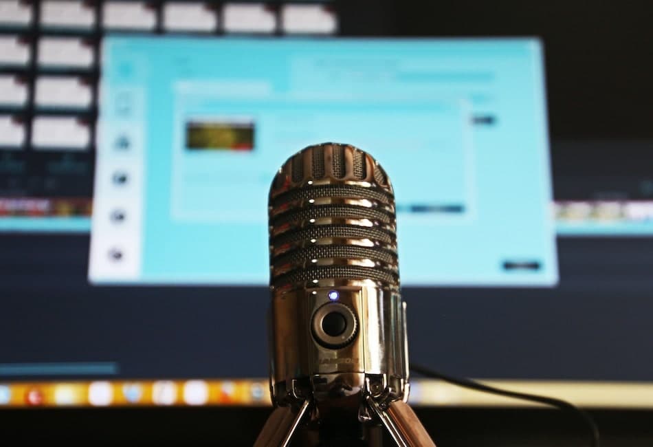 a podcast microphone equipment in front of a desktop screen