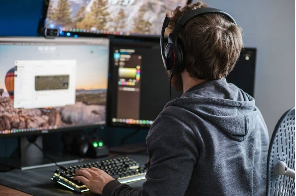 A man about to create a music visualizer using a video editing software on his desktop